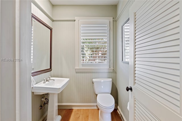 bathroom featuring hardwood / wood-style floors and toilet