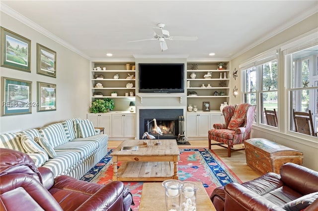 living room featuring ornamental molding, light hardwood / wood-style floors, and built in features