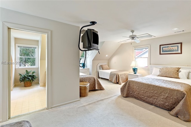 bedroom featuring ceiling fan, carpet flooring, vaulted ceiling, and multiple windows