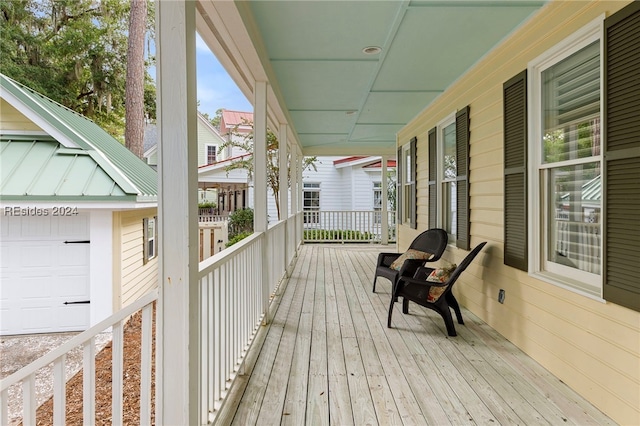 deck featuring a garage and a porch