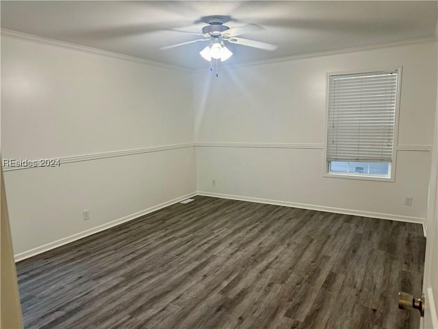 empty room featuring dark wood-type flooring, ceiling fan, and ornamental molding