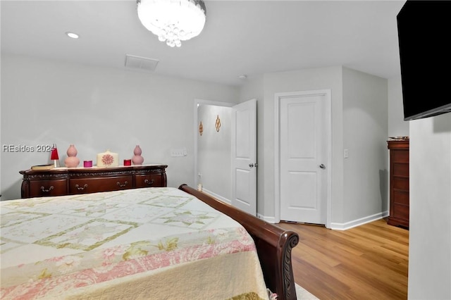 bedroom with wood-type flooring