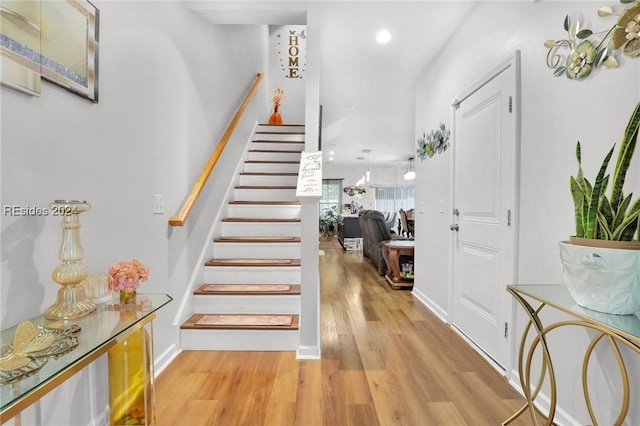 staircase with hardwood / wood-style floors