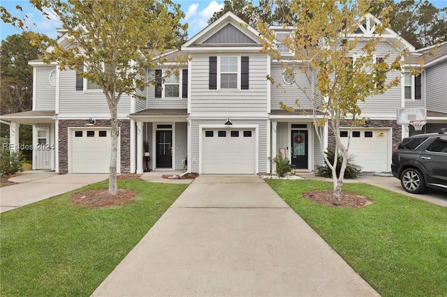 multi unit property featuring a garage and a front lawn