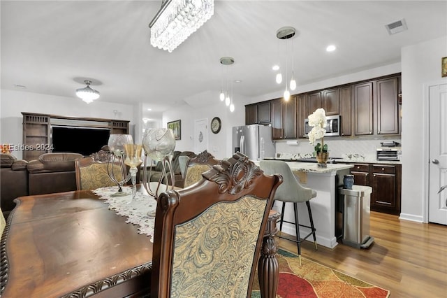 dining space featuring dark wood-type flooring