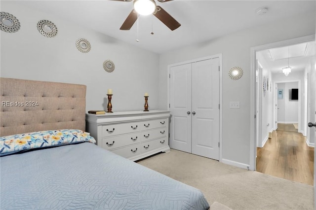 carpeted bedroom featuring a closet and ceiling fan