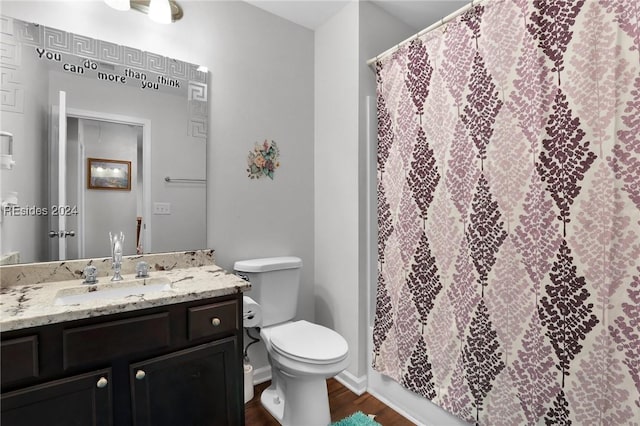 bathroom featuring vanity, hardwood / wood-style flooring, and toilet