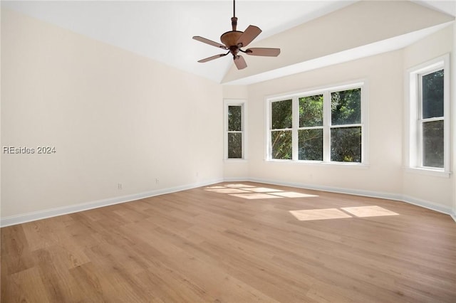 spare room with lofted ceiling, light hardwood / wood-style flooring, and ceiling fan