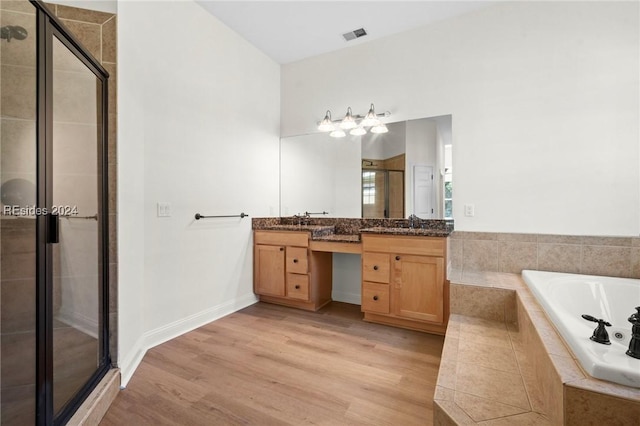 bathroom featuring vanity, wood-type flooring, and independent shower and bath