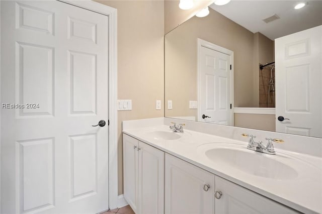 bathroom with tile patterned floors and vanity