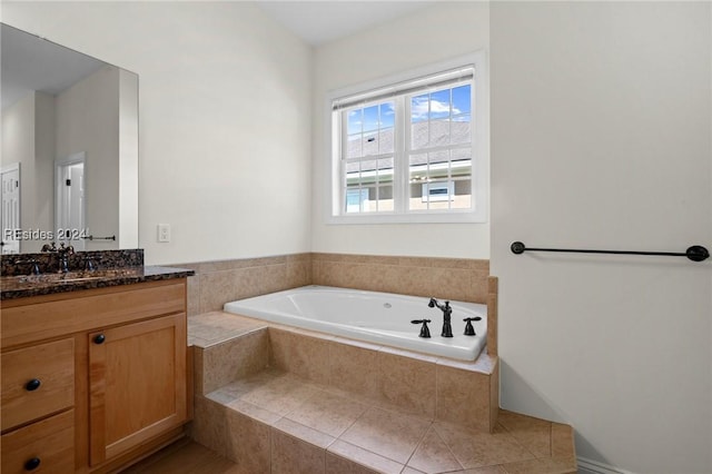 bathroom with a relaxing tiled tub and vanity