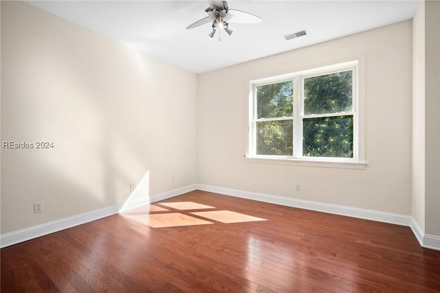 spare room featuring hardwood / wood-style floors and ceiling fan