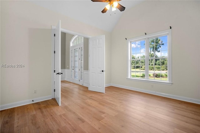 spare room featuring ceiling fan, vaulted ceiling, and light hardwood / wood-style flooring