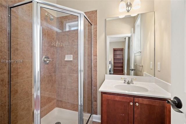 bathroom with vanity and a shower with door