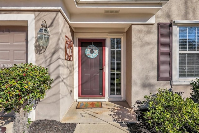 doorway to property featuring a garage