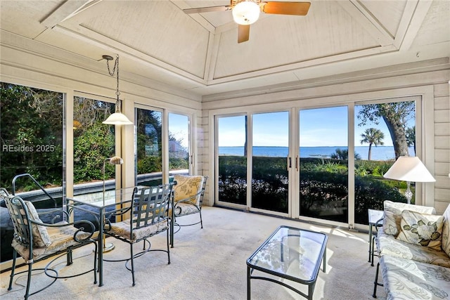 sunroom with a water view and ceiling fan