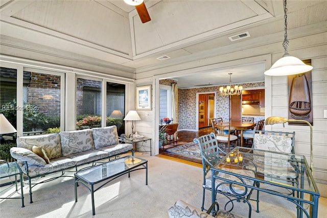 living room with an inviting chandelier and light carpet