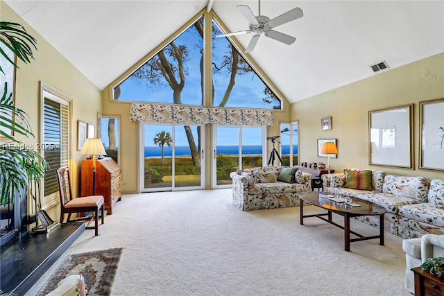 living room featuring a water view, ceiling fan, high vaulted ceiling, and carpet