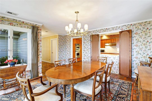 dining space with crown molding and a chandelier