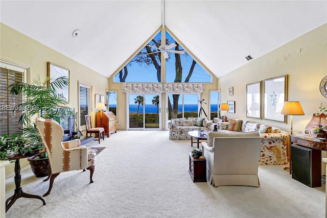 living room with high vaulted ceiling, light carpet, and ceiling fan