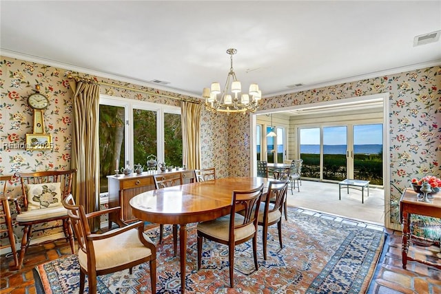 dining room featuring crown molding and a chandelier