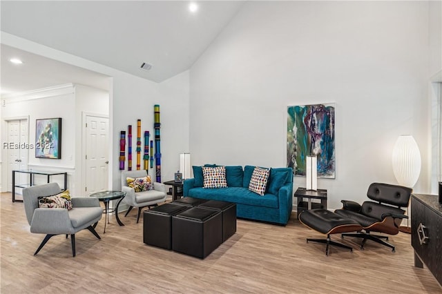 living room with light hardwood / wood-style flooring and vaulted ceiling