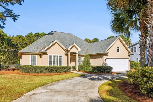 view of front of home with a garage and a front lawn