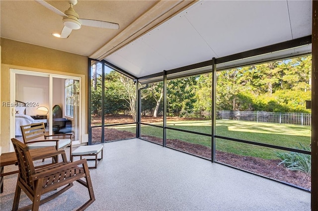 sunroom / solarium with ceiling fan and vaulted ceiling