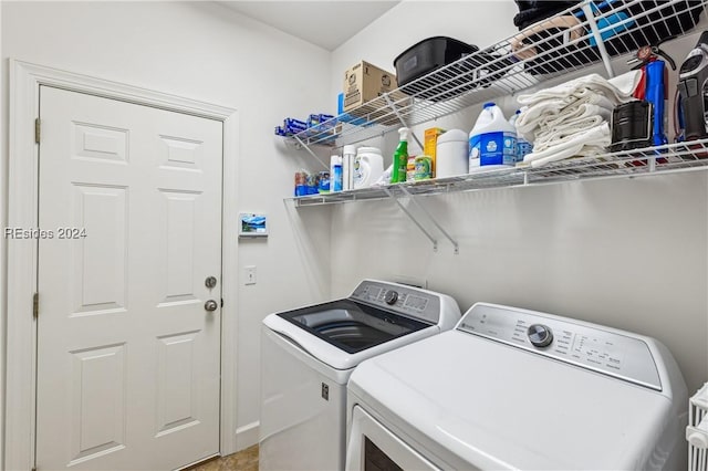 clothes washing area featuring washer and clothes dryer