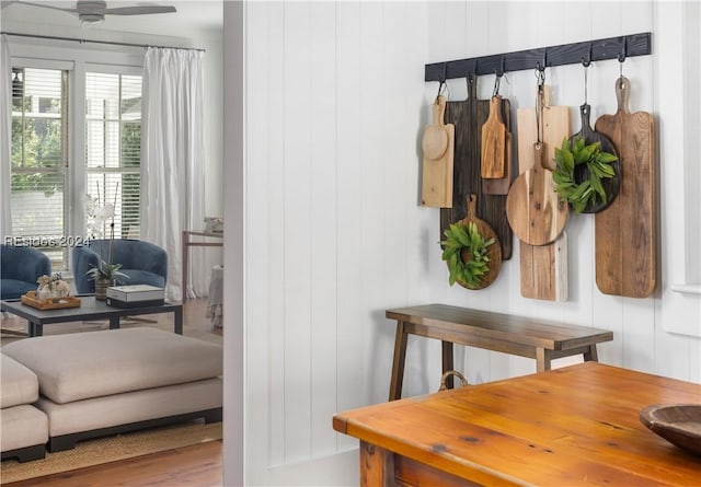 mudroom featuring ceiling fan and wood walls