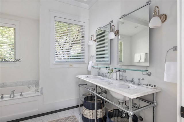 bathroom featuring tile patterned flooring, a bath, and dual sinks