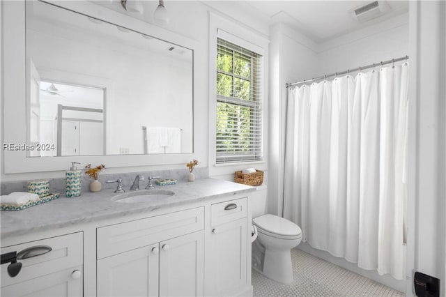 bathroom featuring vanity, tile patterned floors, toilet, and walk in shower