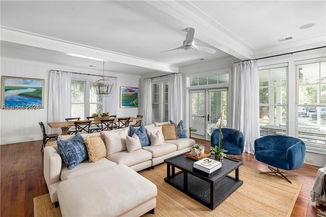 living room with ornamental molding, plenty of natural light, beam ceiling, and light hardwood / wood-style flooring