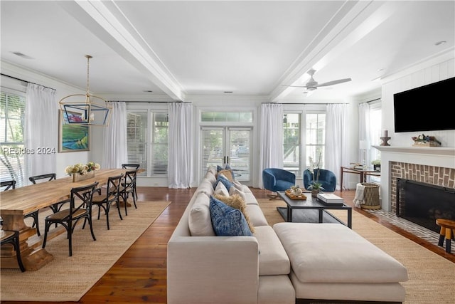 living room with crown molding, plenty of natural light, and wood-type flooring