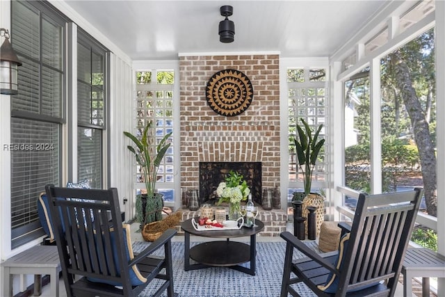 sunroom / solarium with plenty of natural light and a fireplace