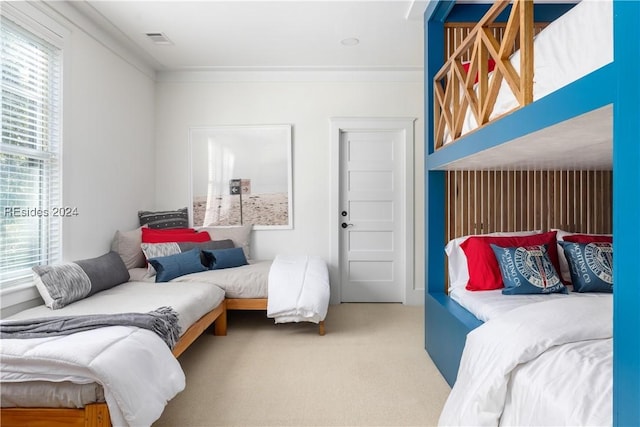 carpeted bedroom with ornamental molding