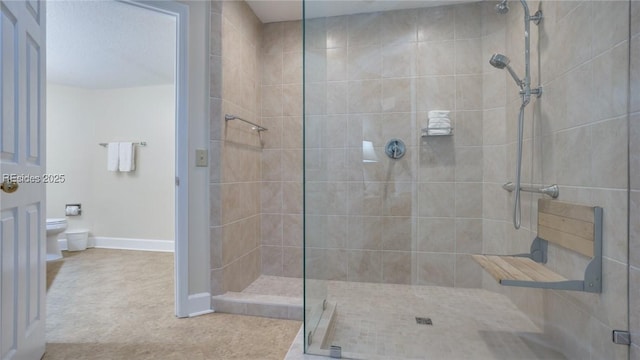 bathroom featuring toilet and tiled shower