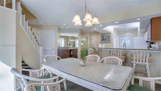 dining room with a notable chandelier and sink