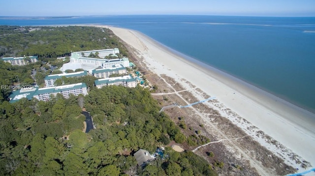 birds eye view of property with a water view and a beach view