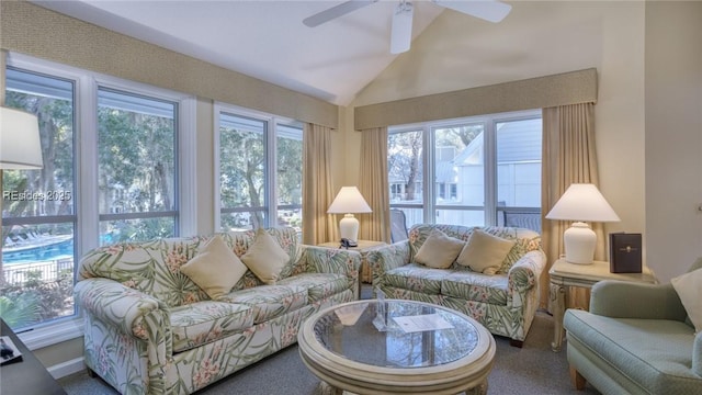 sunroom with ceiling fan and vaulted ceiling