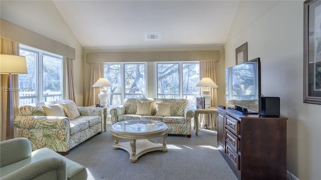 carpeted living room featuring lofted ceiling and plenty of natural light