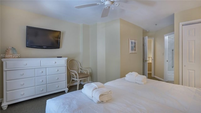 carpeted bedroom with ensuite bathroom and ceiling fan