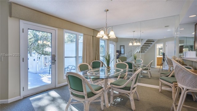 carpeted dining area with plenty of natural light and a chandelier