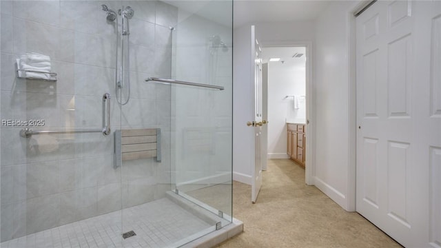 bathroom with vanity and a shower with door