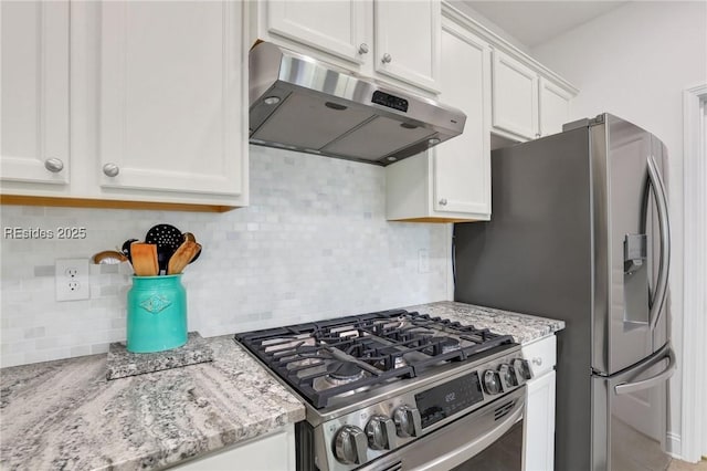 kitchen featuring light stone counters, backsplash, white cabinets, and appliances with stainless steel finishes