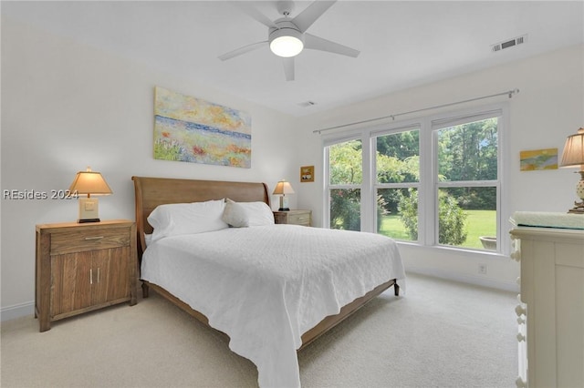 bedroom with ceiling fan and light colored carpet