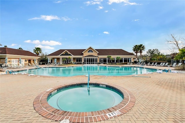 view of swimming pool featuring a community hot tub and a patio