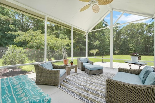 sunroom featuring lofted ceiling, plenty of natural light, and ceiling fan