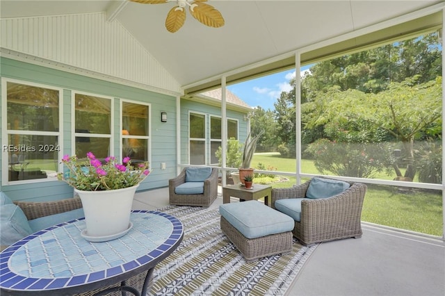 sunroom / solarium featuring lofted ceiling and ceiling fan