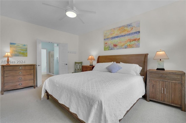 carpeted bedroom featuring ensuite bathroom and ceiling fan